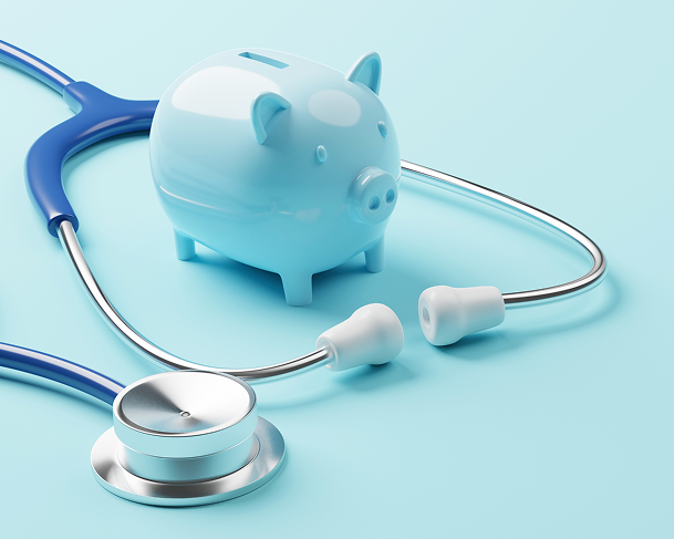 Photo of piggy bank next to stethoscope