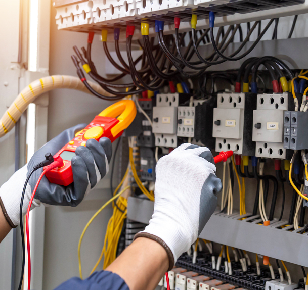 Photo of hands using voltmeter to measure electrical current